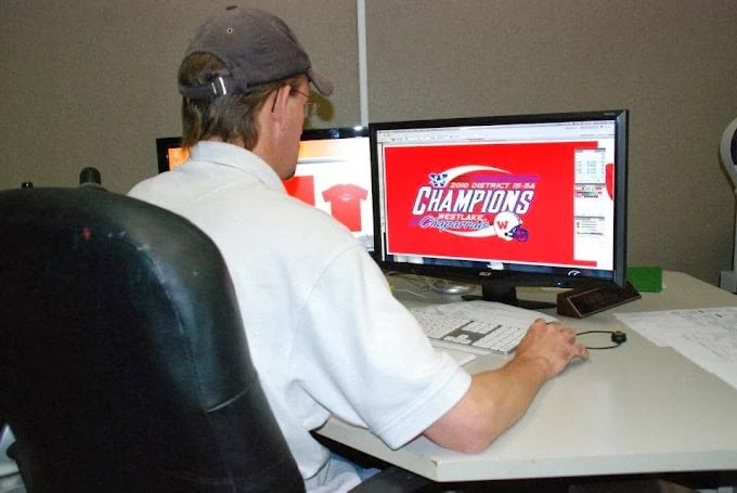 A RiverCity employee digitizing a logo on his computer.