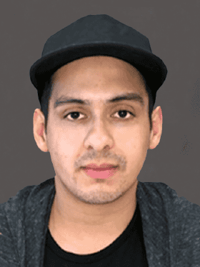 A young man with short black hair wearing a black cap and a dark grey sweater, looking directly at the camera.